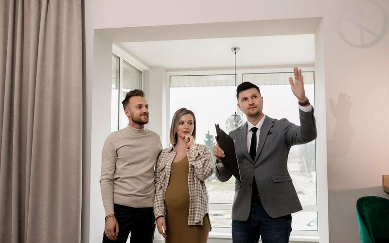 A pregnant woman and her partner explore a new house with a real estate agent